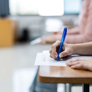 close-up-young-female-university-students-concentrate-doing-examination-classroom-girl-student-writes-answer-examinations-answer-sheet-classroom
