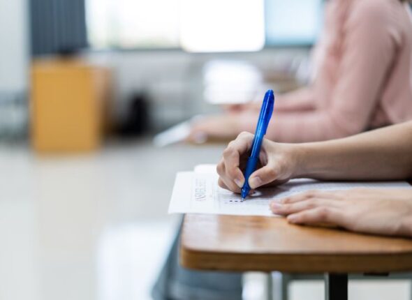 close-up-young-female-university-students-concentrate-doing-examination-classroom-girl-student-writes-answer-examinations-answer-sheet-classroom