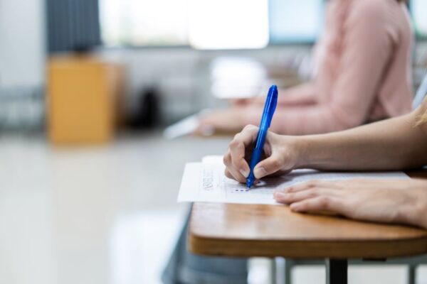 close-up-young-female-university-students-concentrate-doing-examination-classroom-girl-student-writes-answer-examinations-answer-sheet-classroom