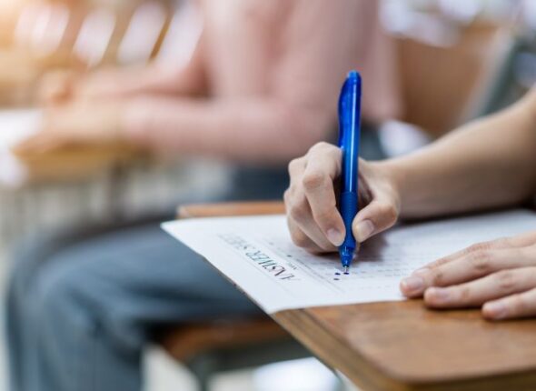 close-up-young-female-university-students-concentrate-doing-examination-classroom-girl-student-writes-answer-examinations-answer-sheet-classroom