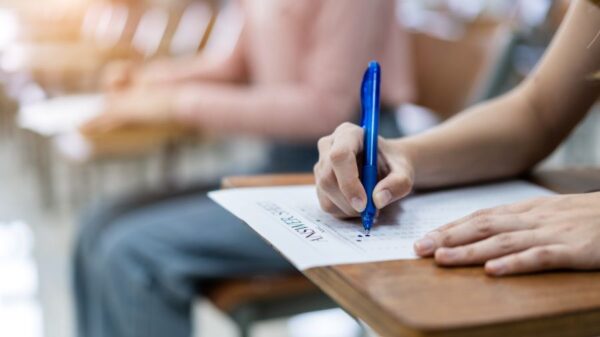 close-up-young-female-university-students-concentrate-doing-examination-classroom-girl-student-writes-answer-examinations-answer-sheet-classroom
