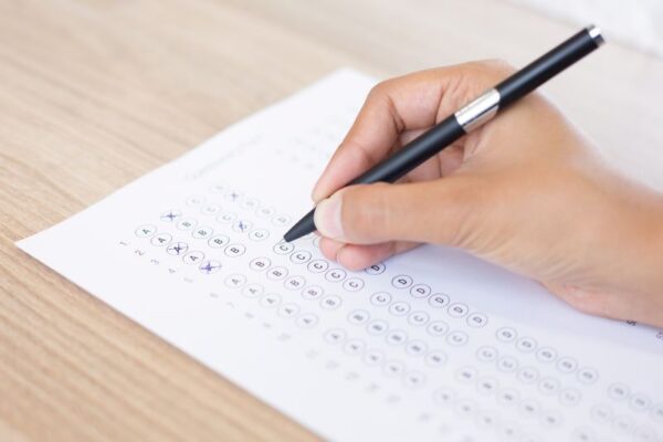 closeup-person-filling-out-questionary-form