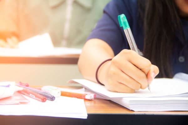 hands-university-student-study-quiz-test-exam-from-teacher-large-lecture-classroom-school