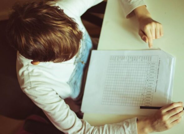 high-angle-view-boy-writing-document