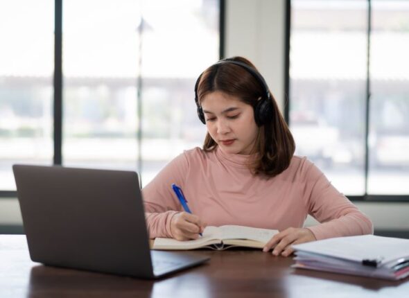 smiling-asian-girl-student-wears-wireless-headphones-write-notebook-study-language-online-watch-listen-lecturer-webinar-via-video-call-e-learning-home-distance-education