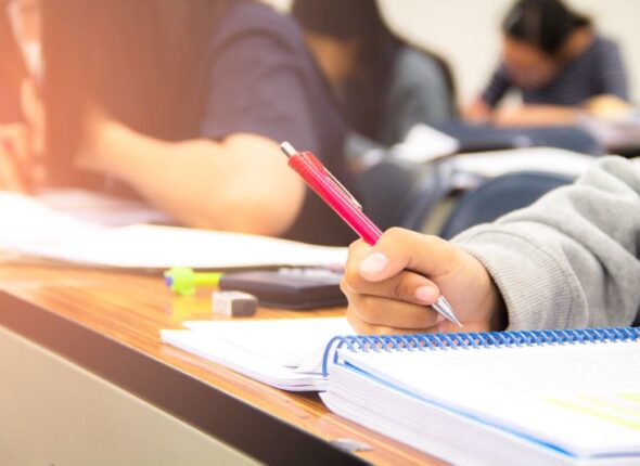 university-students-quiz-test-studies-from-teacher-large-lecture-room-students-uniform-attending-exam-classroom-educational-school