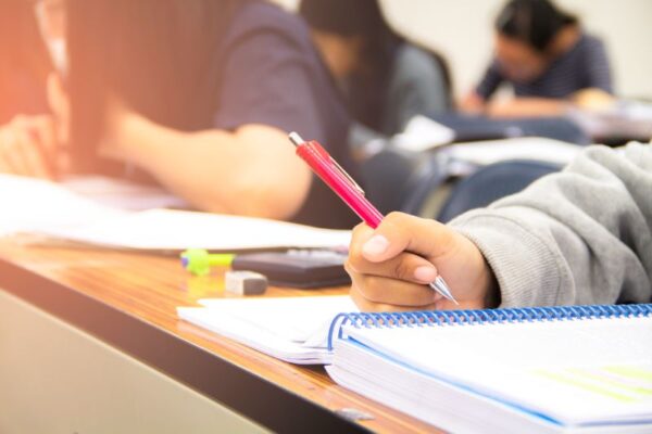 university-students-quiz-test-studies-from-teacher-large-lecture-room-students-uniform-attending-exam-classroom-educational-school